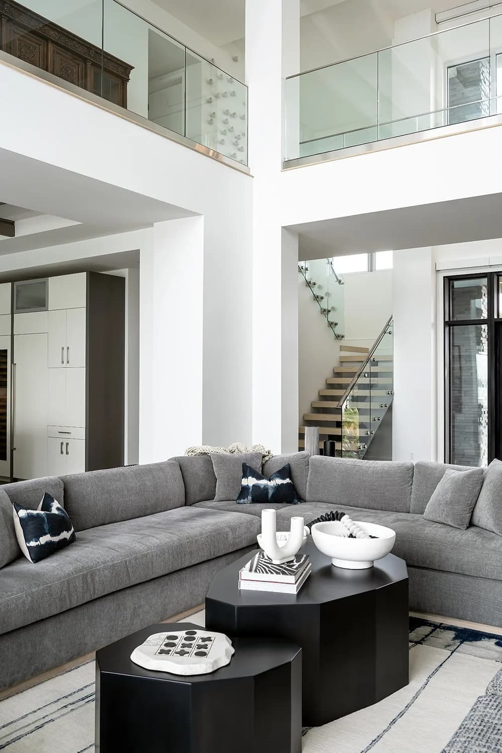 Bird Key Bayfront double-height living room with glass railings