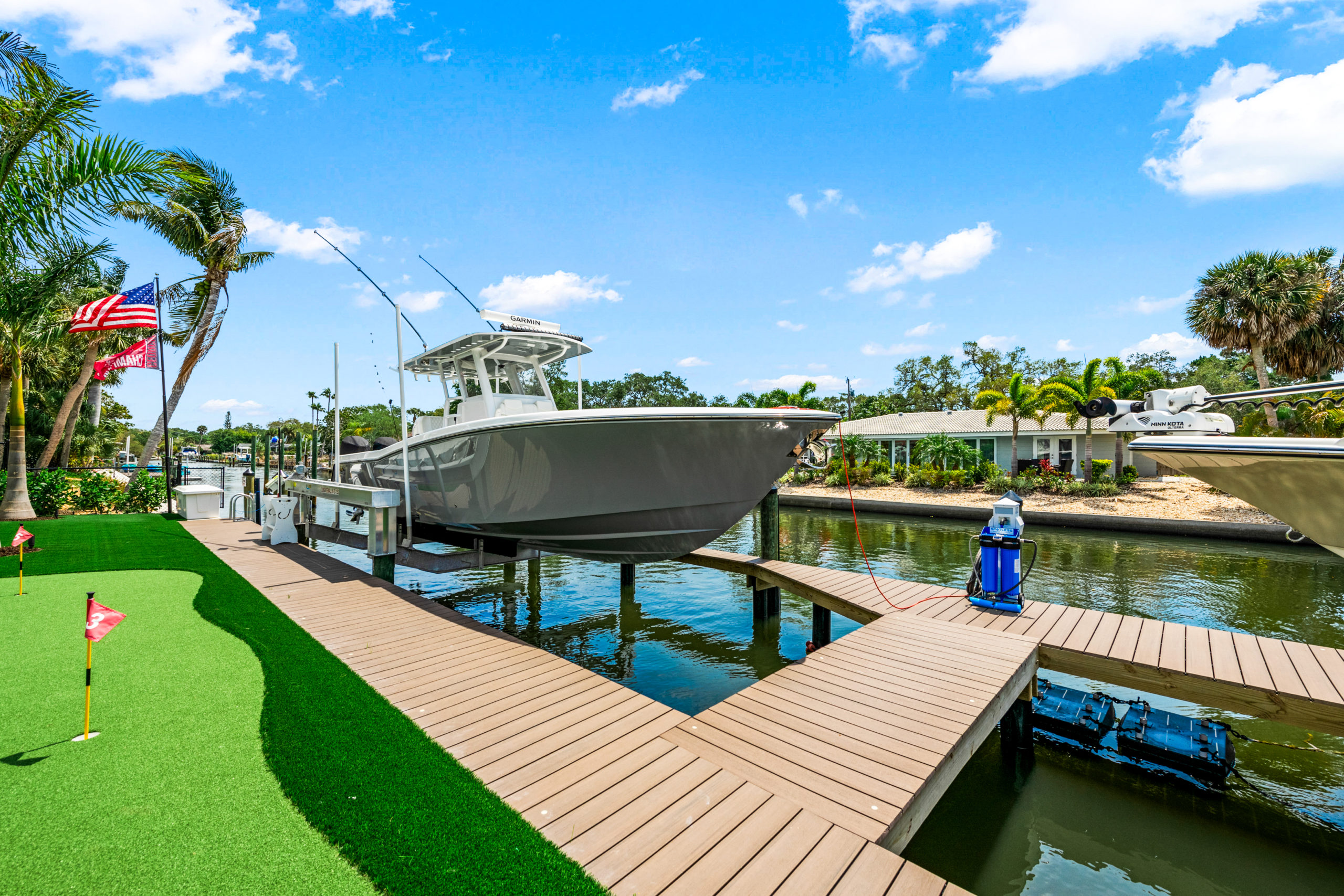 Luxury waterfront custom home property with private dock boat lift and putting green in Sarasota FL built by Nutter Custom Construction