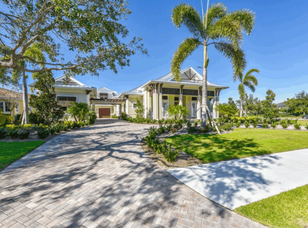 British West Indies luxury custom homeSarasota British West Indies luxury custom home with metal roof paver driveway and tropical landscaping in Sarasota FL built by Nutter Custom Construction