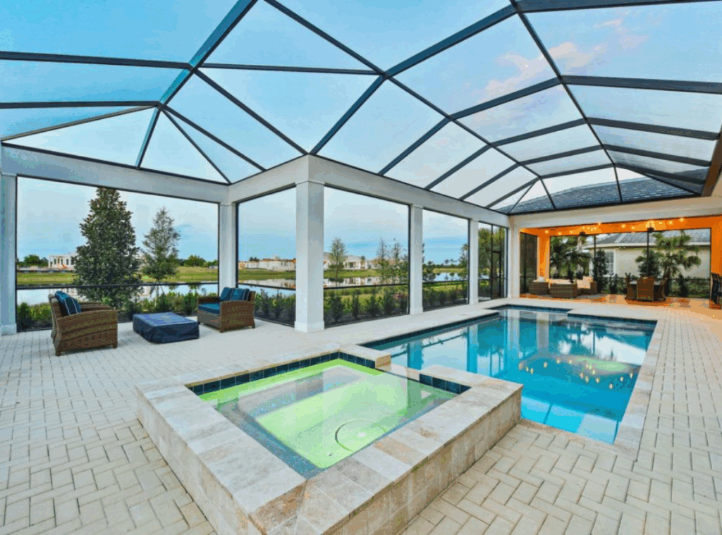 Nutter Custom Construction luxury outdoor living space in Sarasota Luxury custom home screened pool enclosure with spa paver deck and lake views in Sarasota FL built by Nutter Custom Construction