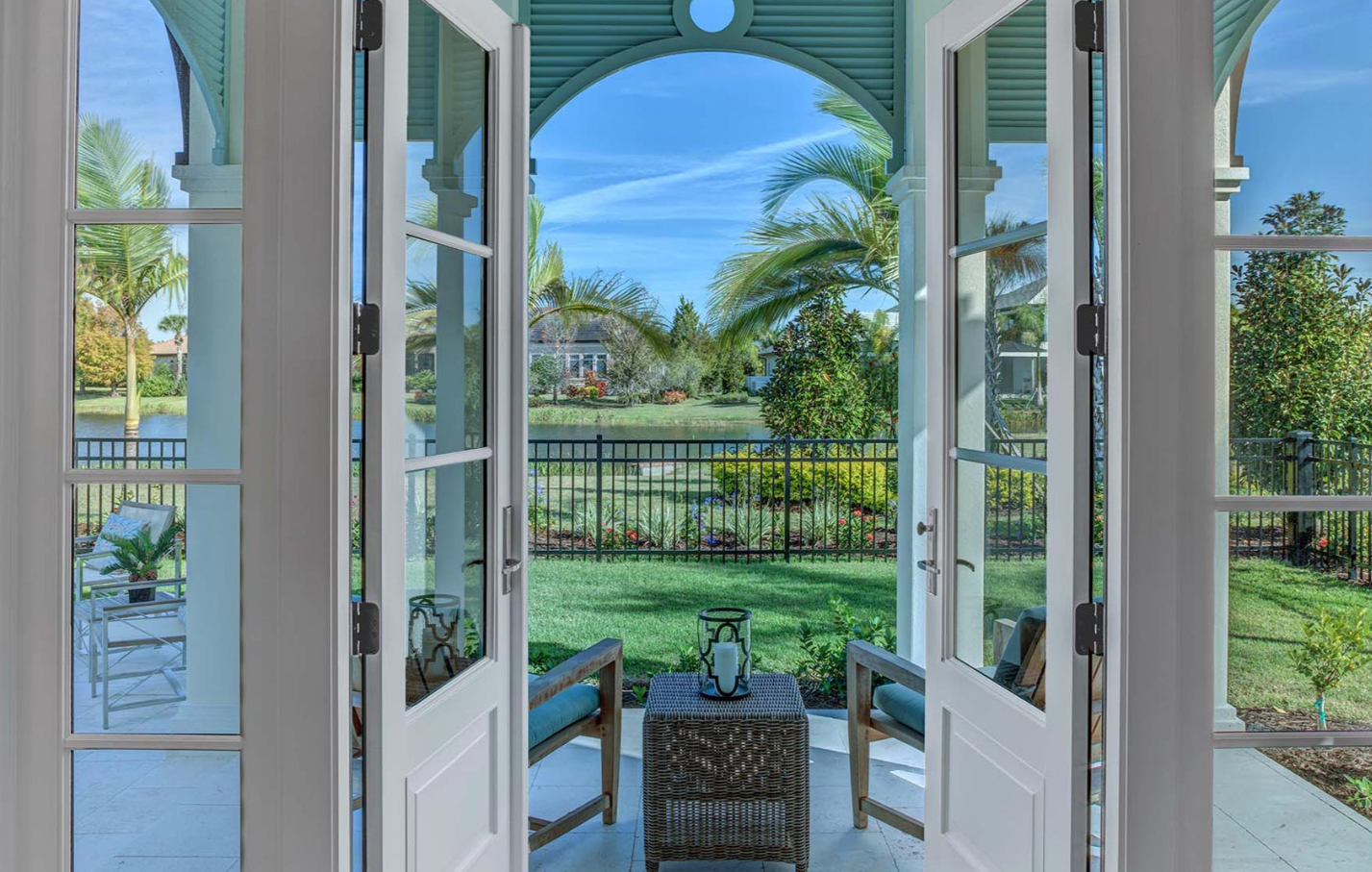 Luxury custom home covered porch with folding glass doors and golf course views in Sarasota FL built by Nutter Custom Construction