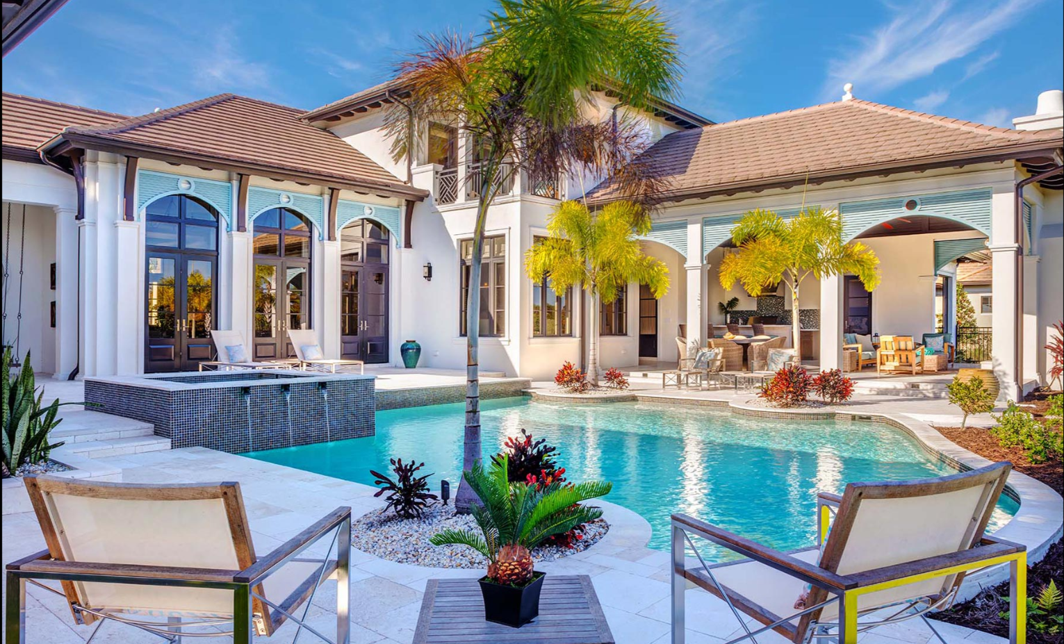 Luxury custom home pool and outdoor living area with tropical landscaping and covered lanai in Sarasota FL built by Nutter Custom Construction
